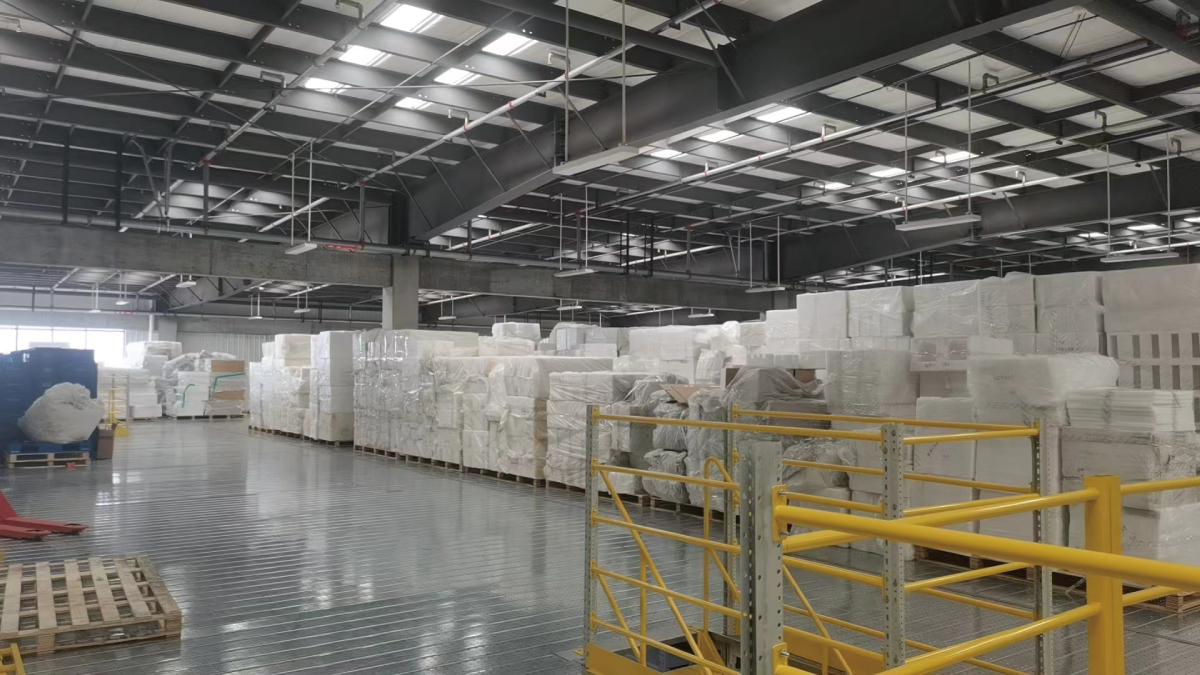 Warehouse operation area below a multi-tier mezzanine platform